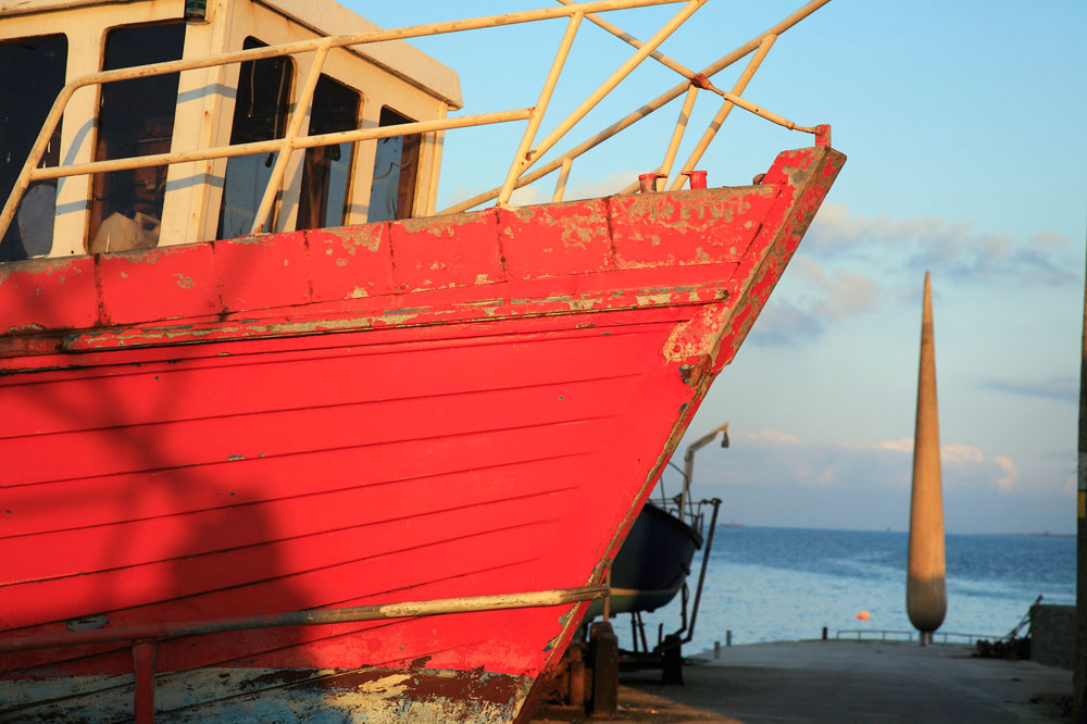 photo of the fid with a red boat in the four groung