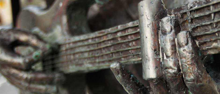 close up photo of Rory Gallagher Statue gutair