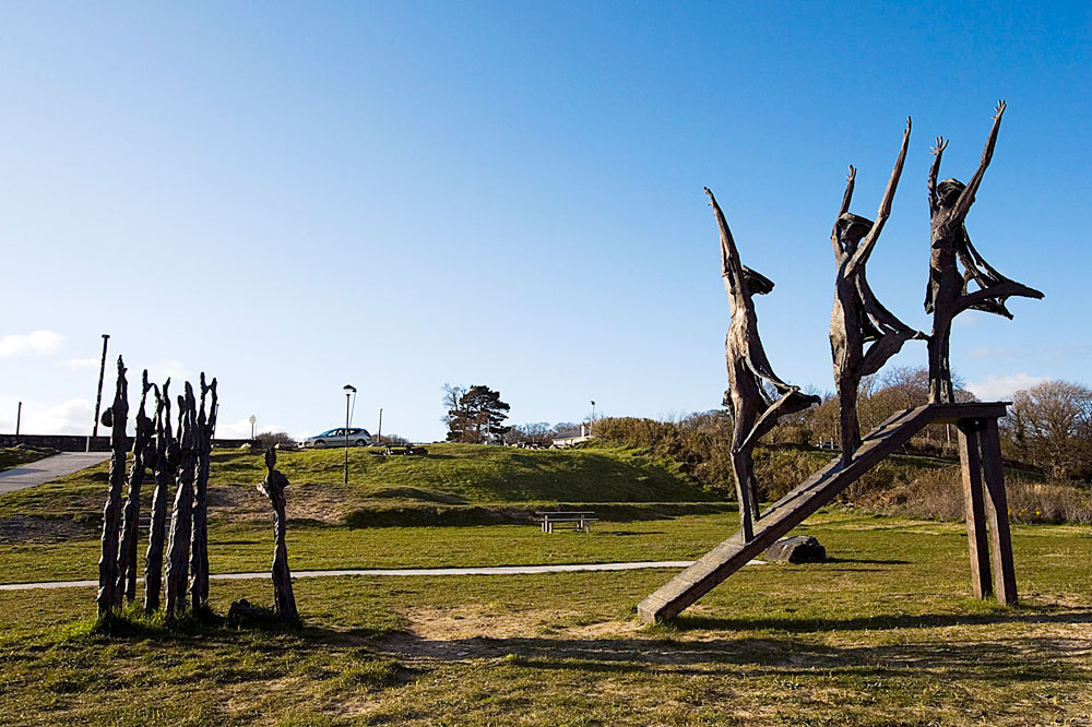 photo of statues near the beach