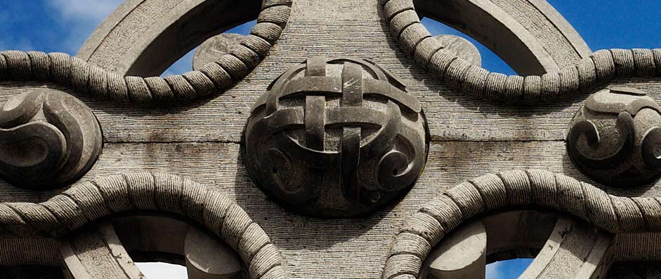 close up photo of carving on stone cross